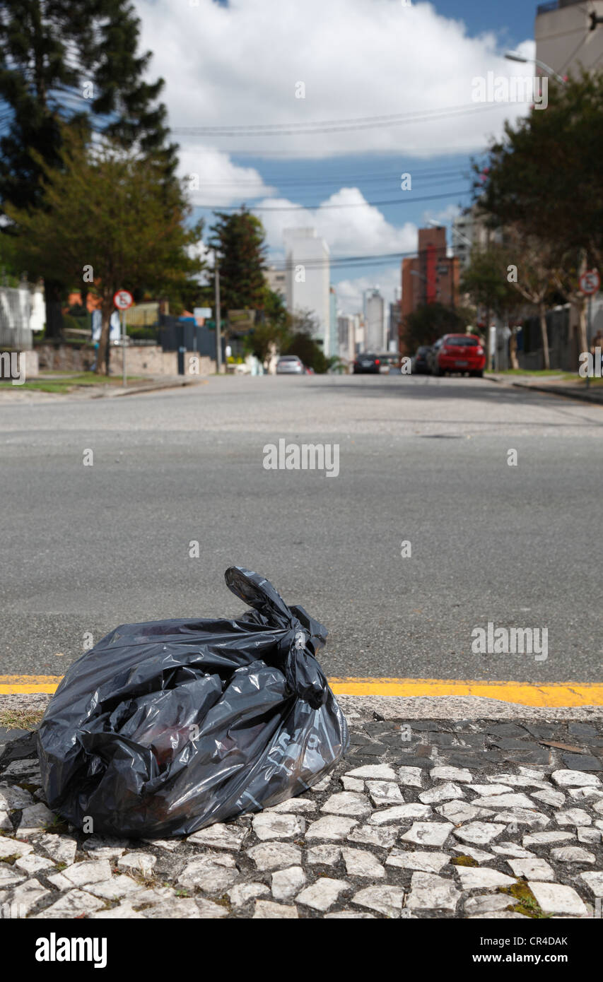 Garbage bag waiting by the roadside of a major city to be picked up, Curitiba, Parana, Brazil, South America, PublicGround Stock Photo