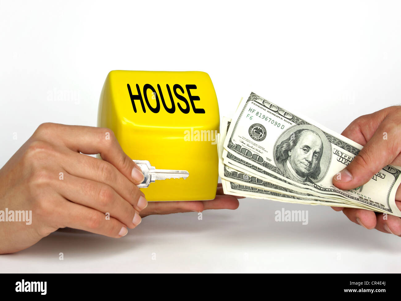 Happy man buying a house with us currency and getting the key to the