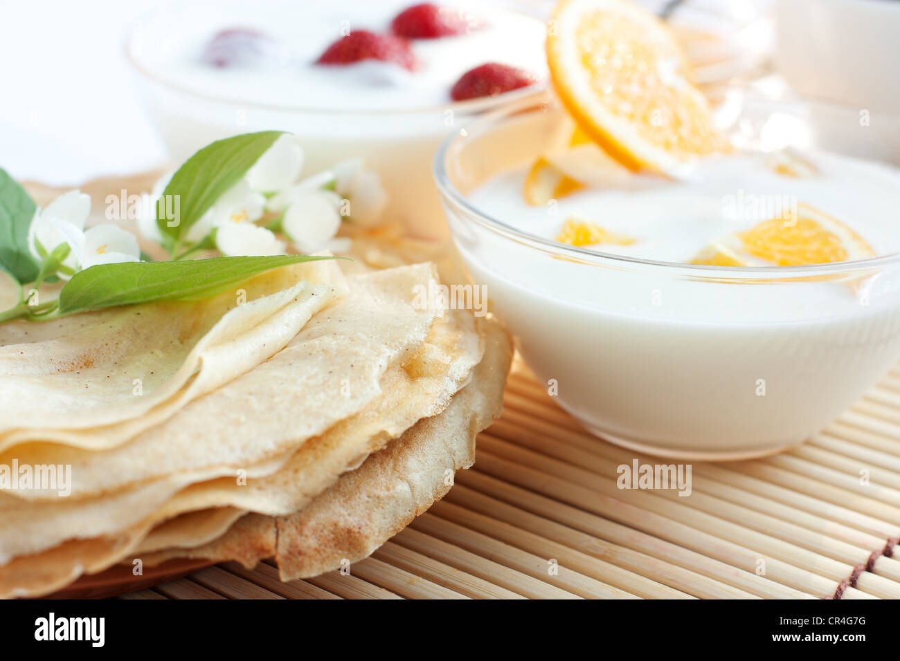Fresh pancakes and orange yogurt. Delicious and easy breakfast Stock Photo