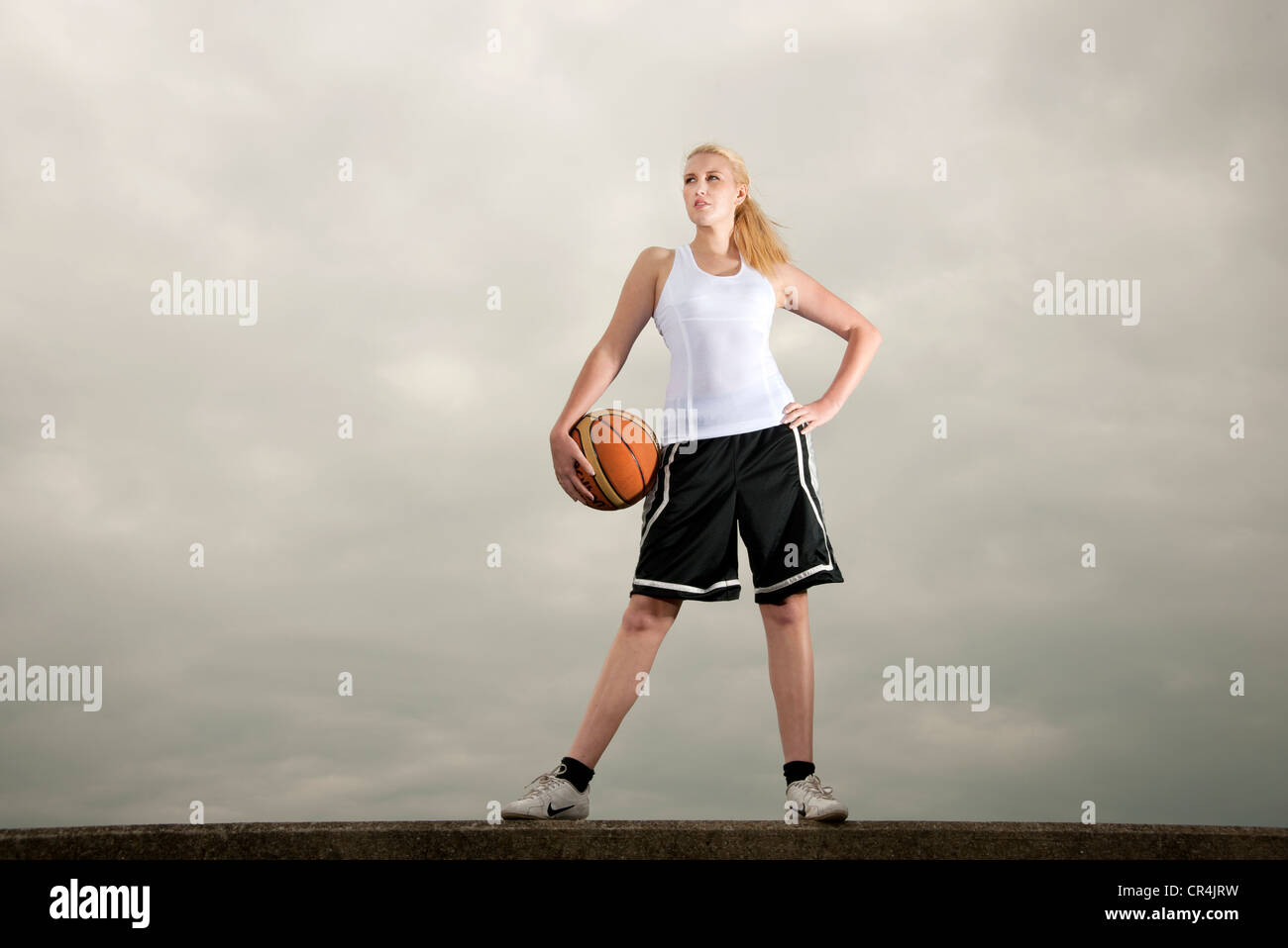 woman holding basketball ball Stock Photo - Alamy