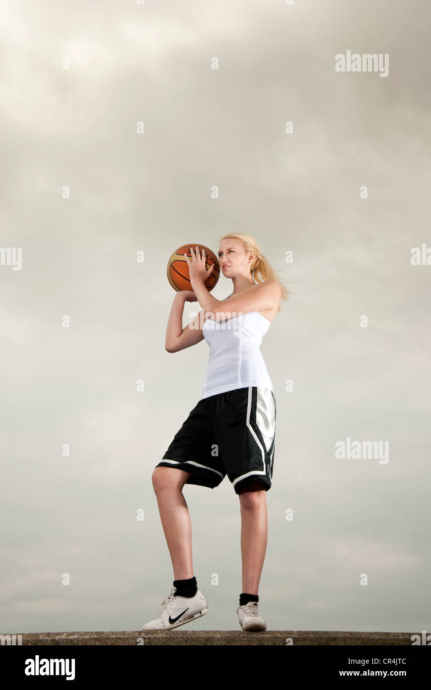 woman holding basketball ball Stock Photo - Alamy