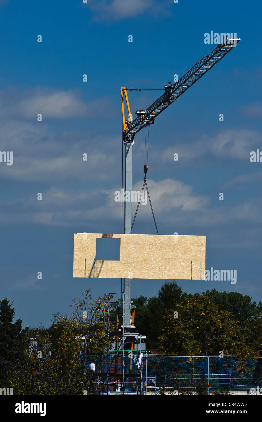 Crane lifting element of a prefabricated house on the construction site Stock Photo