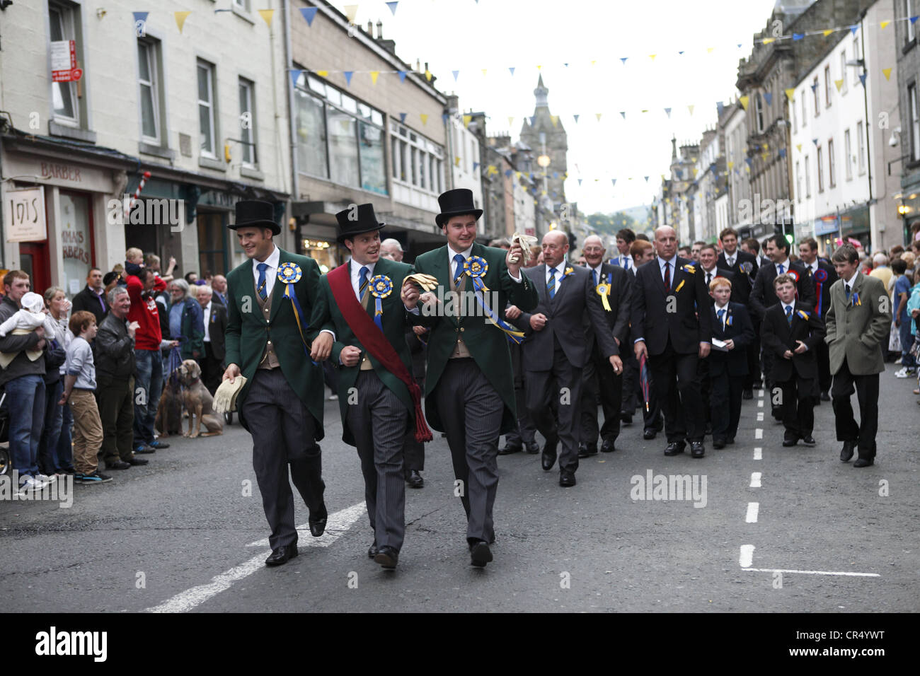 Cornet and supporters parade the High Street during Colour Bussing of Hawick Common-Riding festival in the border town, Scotland Stock Photo