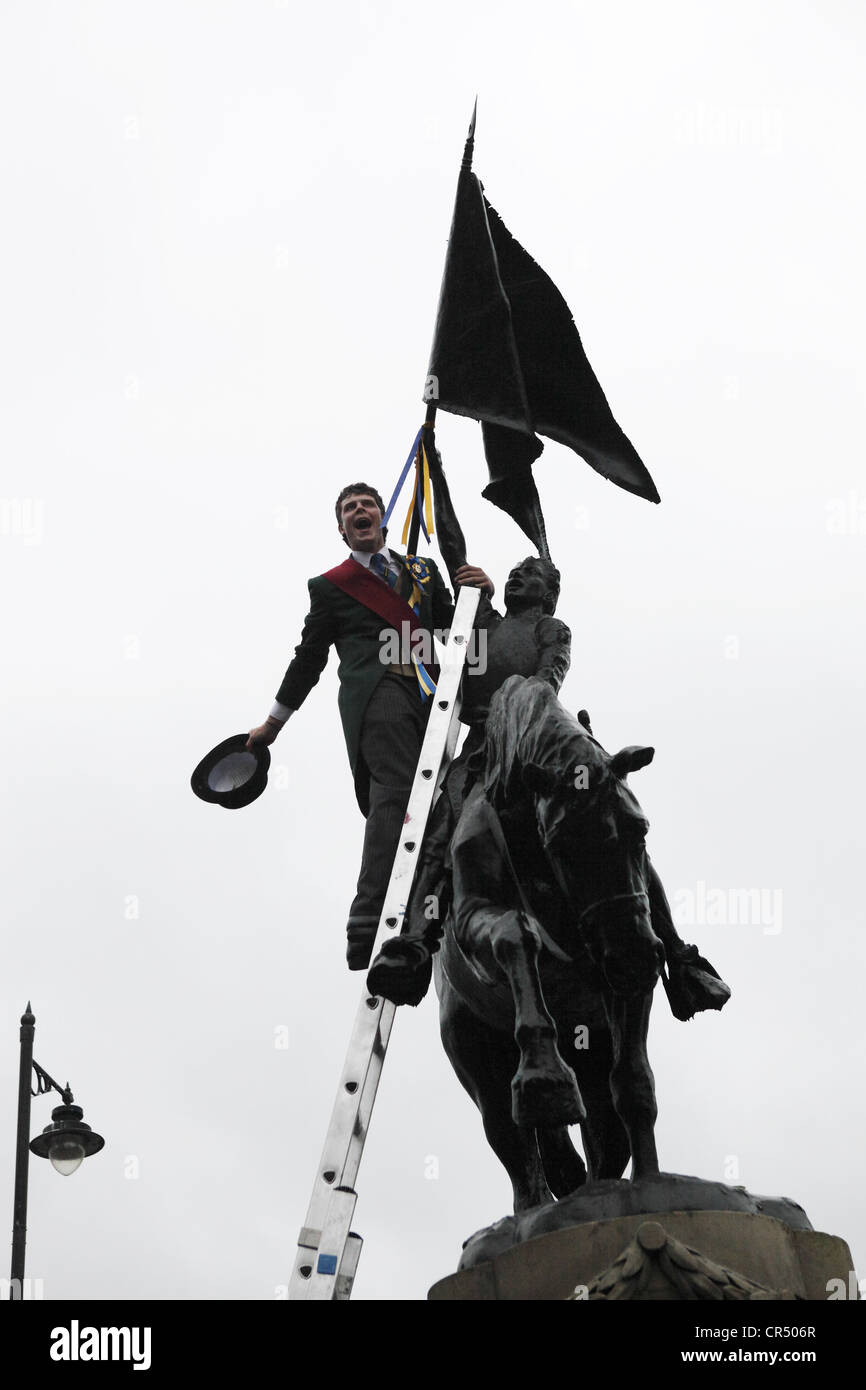 ties ribbons on the 1514 memorial during Colour Bussing of Hawick CommonRiding festival