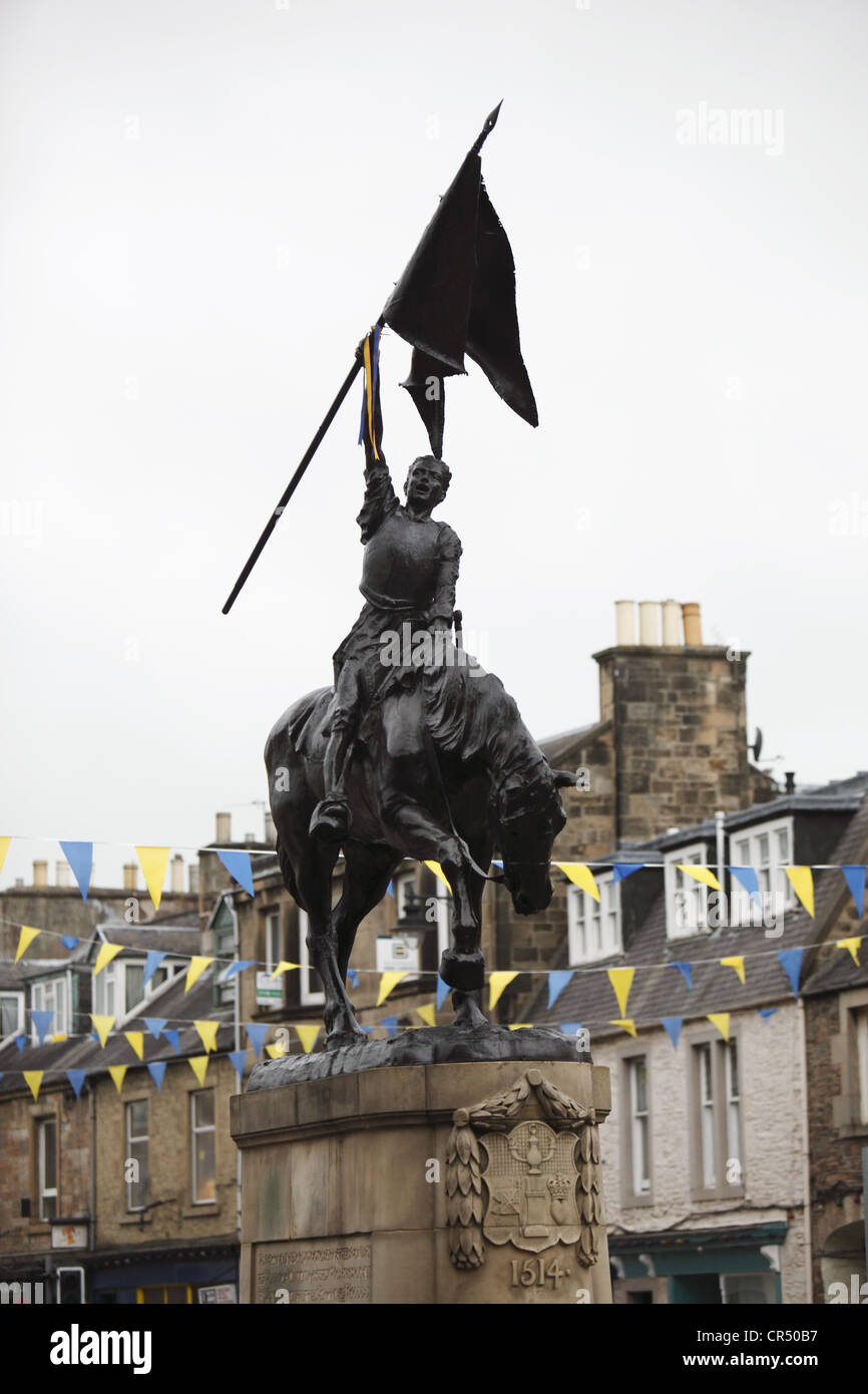 ties ribbons on the 1514 memorial during Colour Bussing of Hawick CommonRiding festival