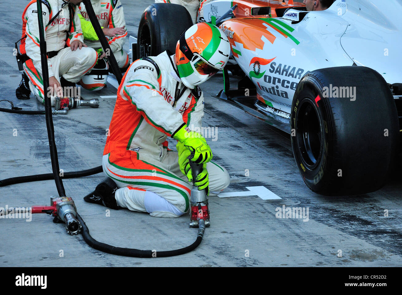 Force India team of technicians testing a tire change in the pit lane of the Yas Marina Circuit on Yas Island during the Grand Stock Photo