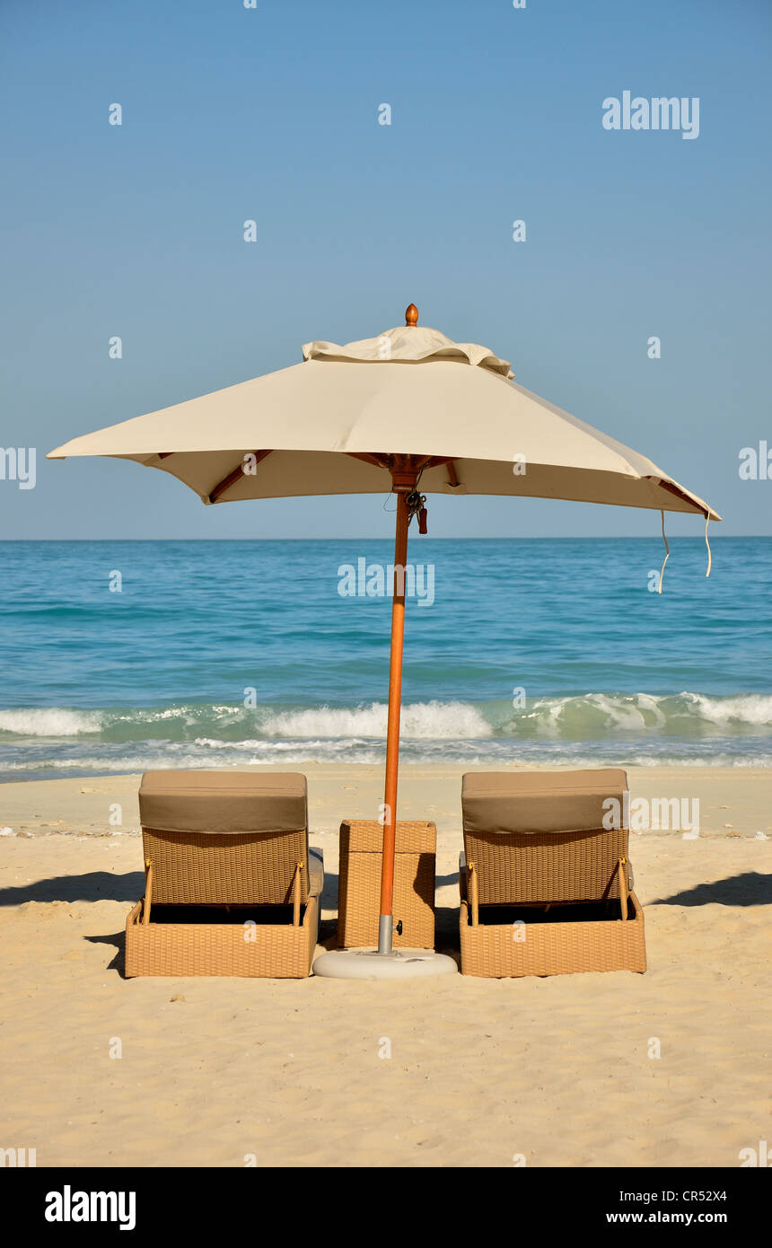 Sunbeds and sunshade on the beach of the Park Hyatt hotel on Saadiyat Island, Abu Dhabi, United Arab Emirates, Arabian Peninsula Stock Photo
