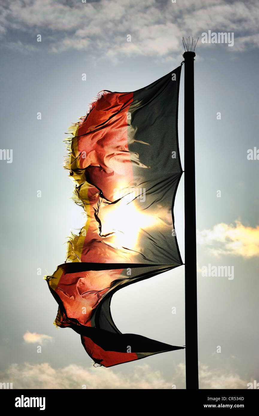Tattered German flag flying in the wind, symbolic image for debt crisis Stock Photo