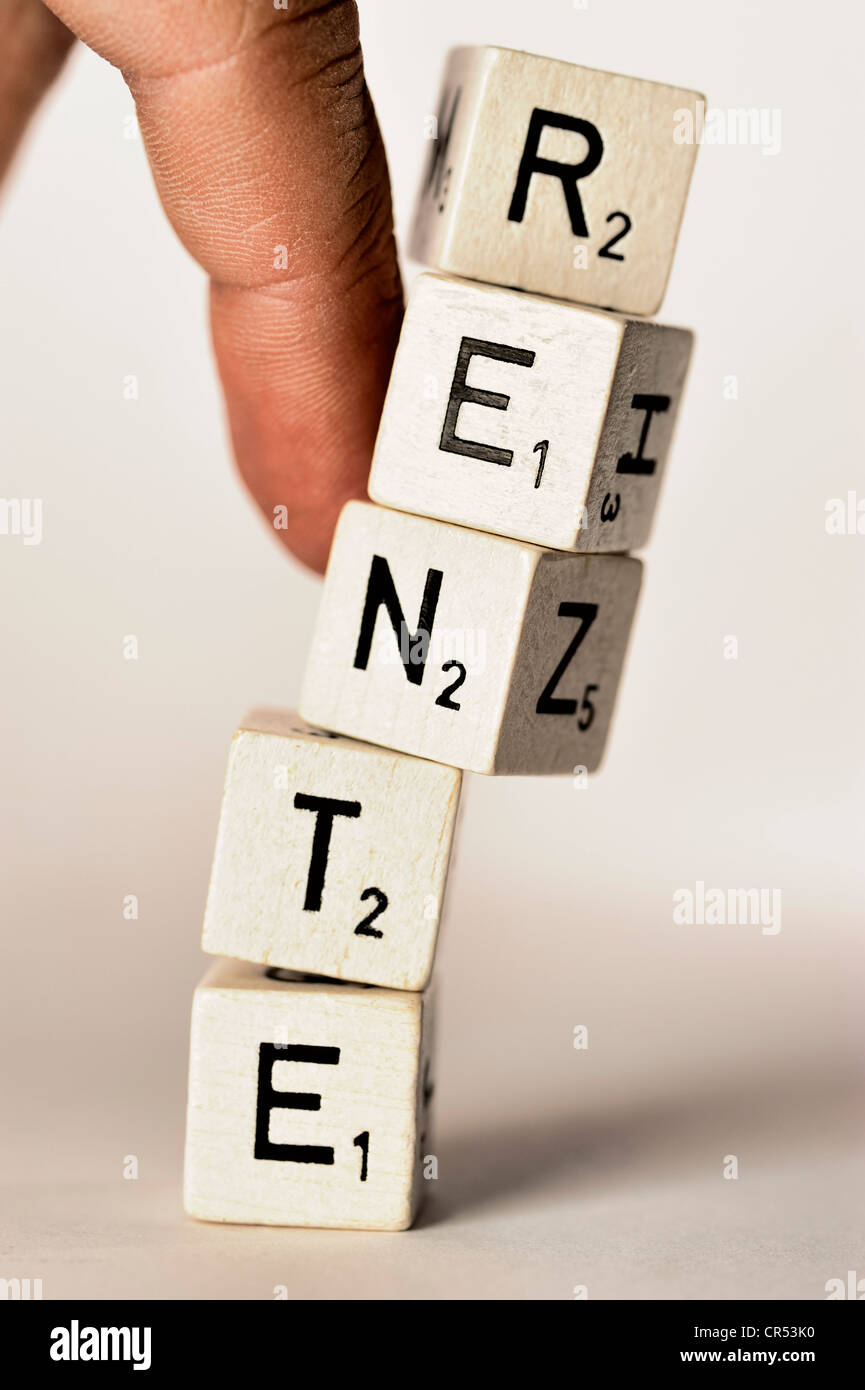 Toppling of a tower of letter blocks, lettering "Rente", German for "pension", symbolic image for the uncertain future of Stock Photo