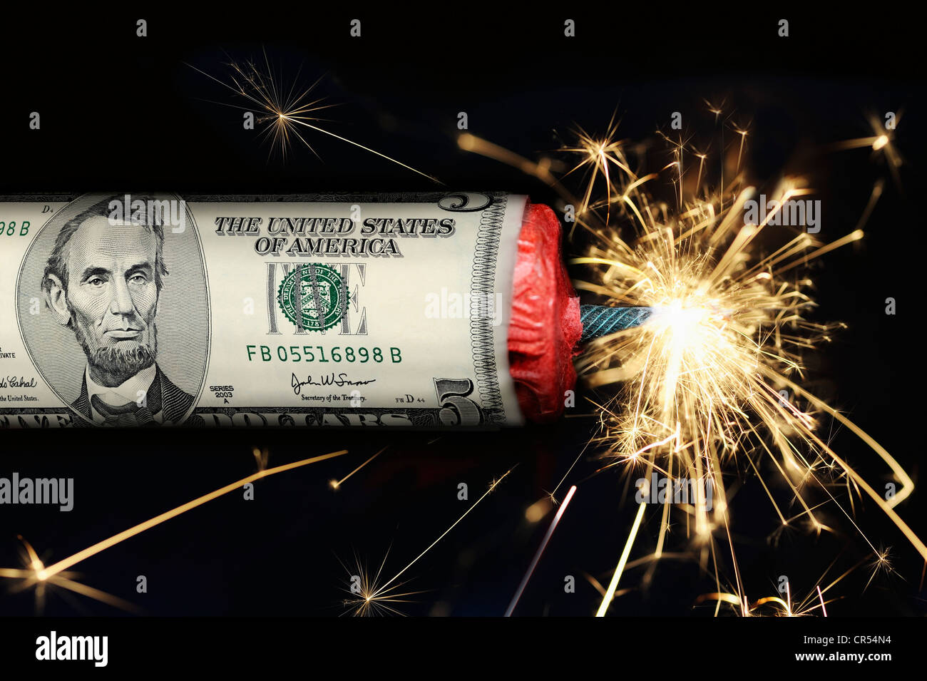 Stick of dynamite with a US-Dollar with a burning fuse, symbolic image of the U.S. national debt Stock Photo