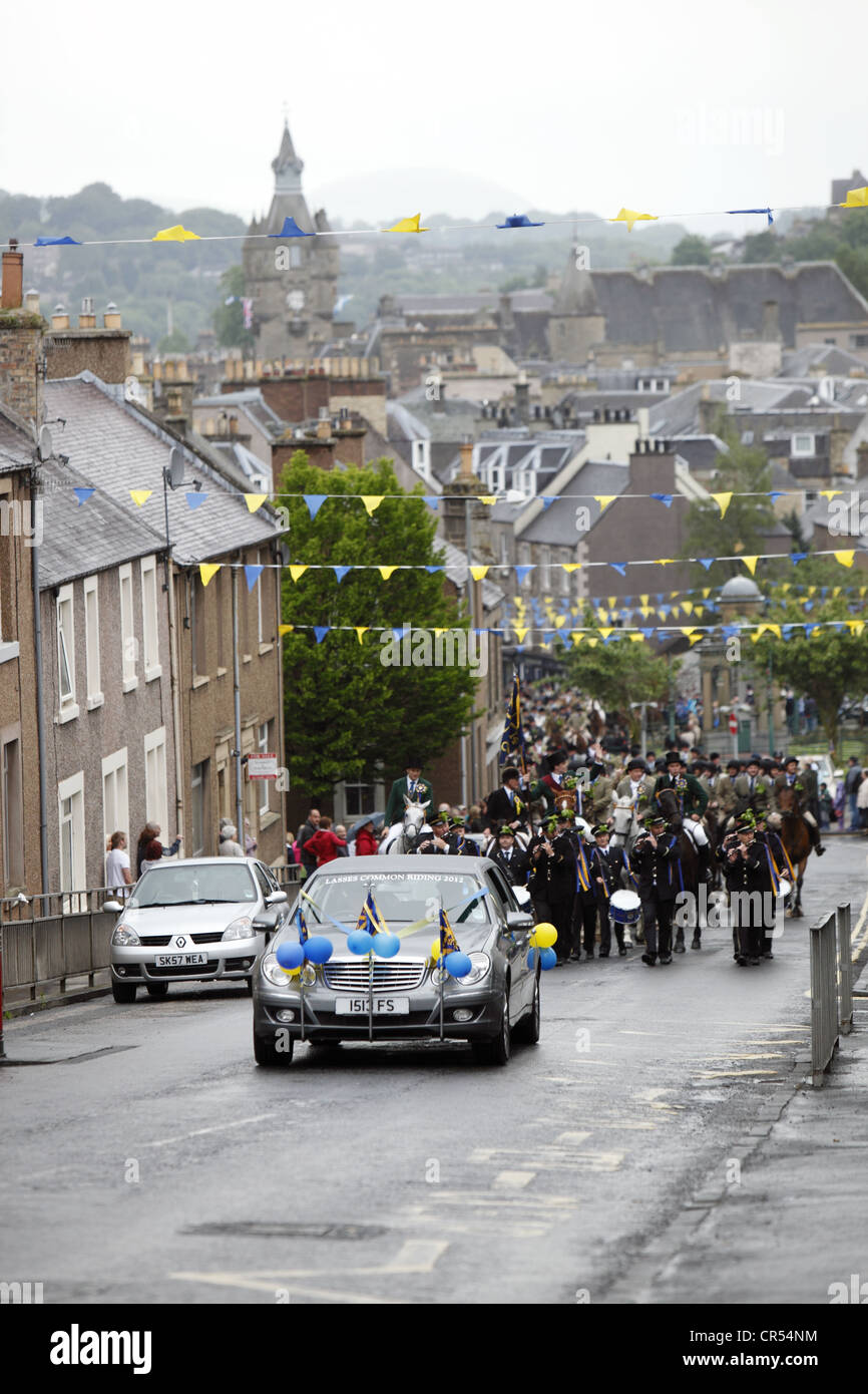 The band, and supporters follow behind Lass to the Moor