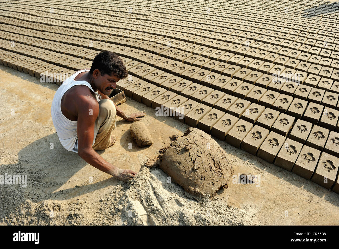 Worker living in bonded labour in a brickyard, most of the workers belong to the Christian minority in Pakistan and are Stock Photo