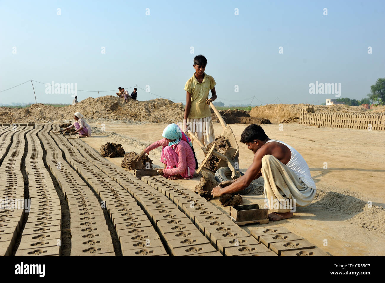 Workers living in bonded labour in a brickyard, most of the workers belong to the Christian minority in Pakistan and are Stock Photo