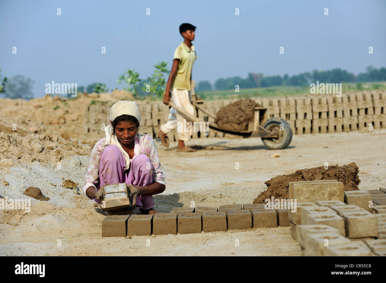 Child labour, 12-year-old girl and her 14-year-old brother working in a brickyard, members of the Christian minority, which is Stock Photo