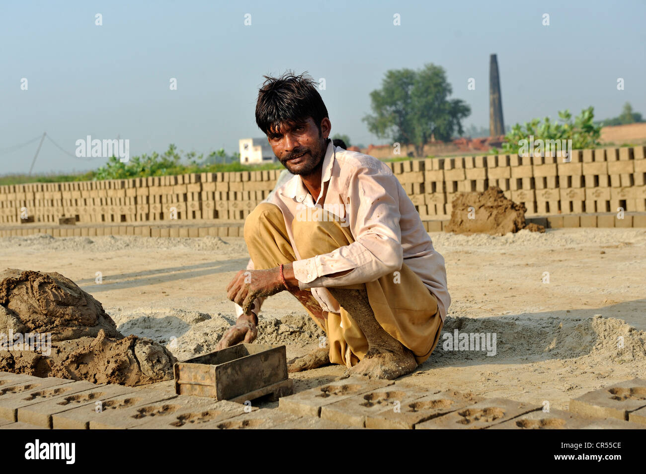 Worker living in bonded labour in a brickyard, most of the workers belong to the Christian minority in Pakistan and are Stock Photo