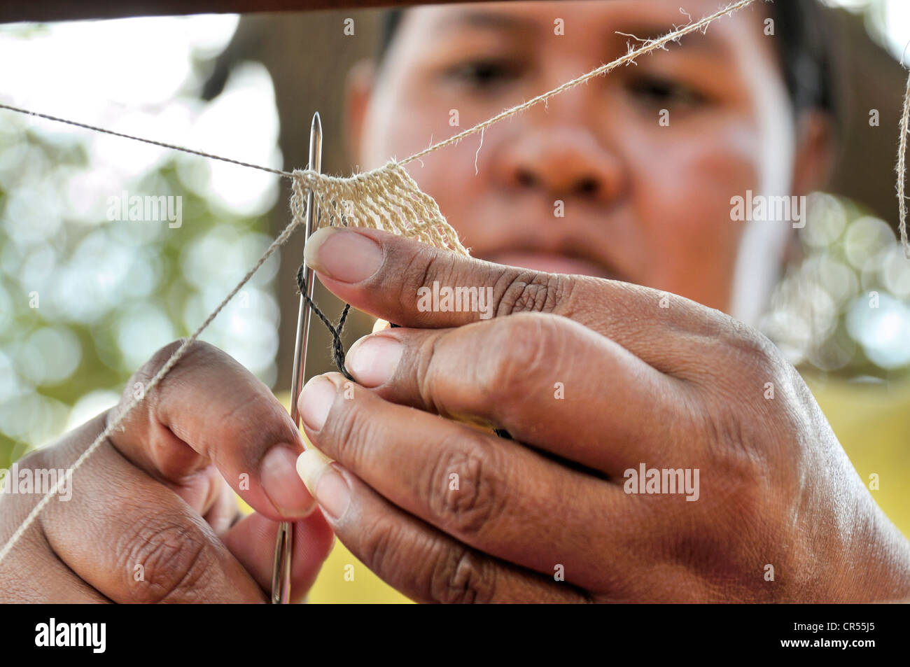 Indigenous woman from the Wichi Indians tribe creating handicrafts from the fibres of the Chaguar Bromeliad (Bromelia Stock Photo