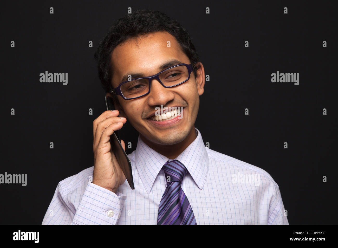 A satisfied customer after talking to customer services over a mobile phone. Stock Photo