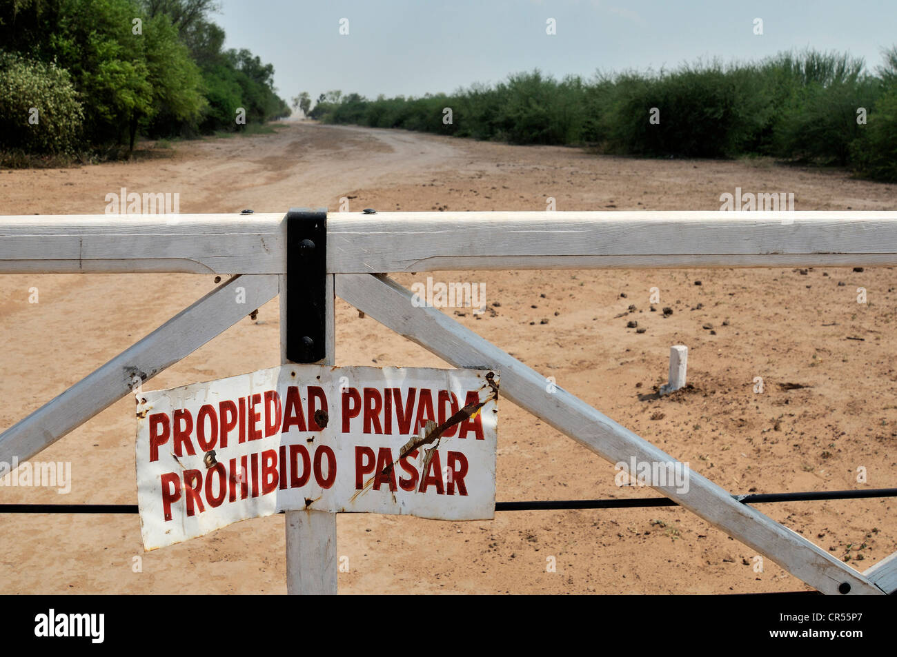 Sign on a gate 'Propiedad privada, Prohibido pasar', 'private property, access prohibited', marking the grounds of a major Stock Photo