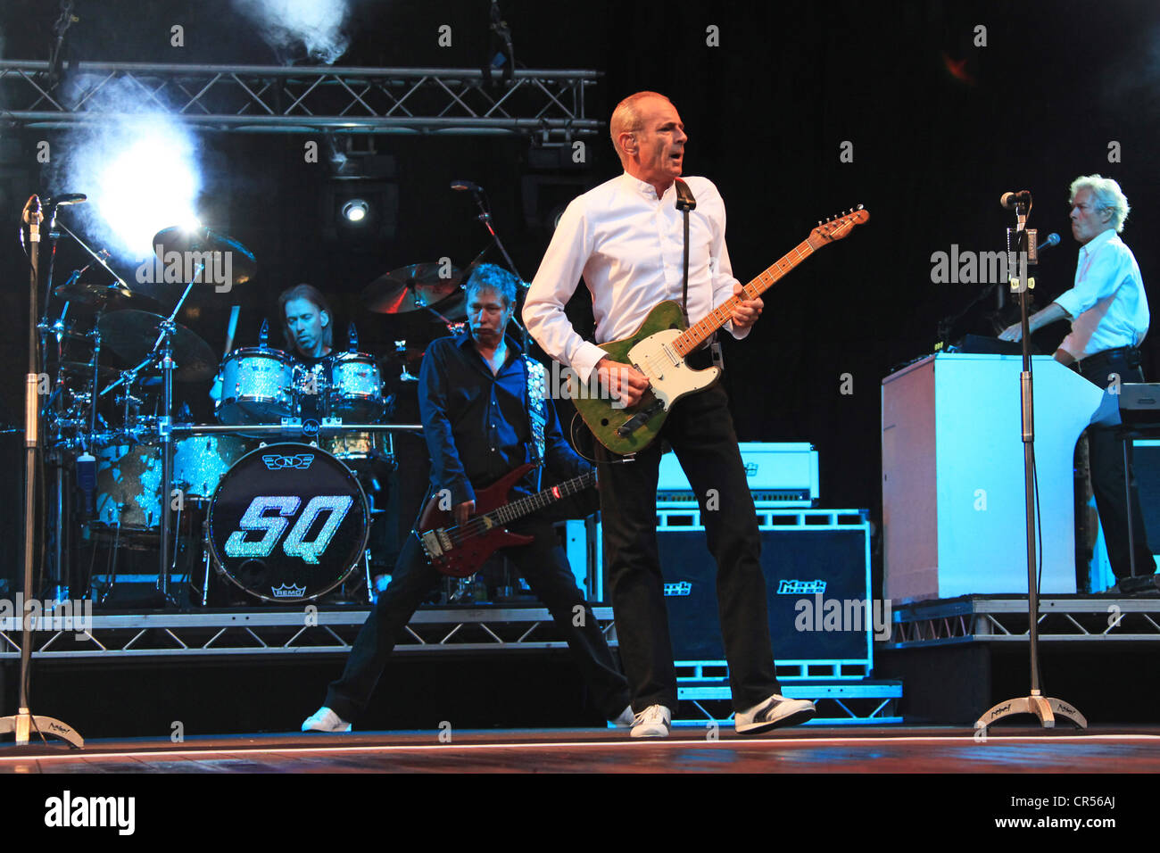 Francis Rossi, in the foreground, performing with his band Status Quo, Freilichtbuehne Junge Garde outdoor stage, Dresden Stock Photo