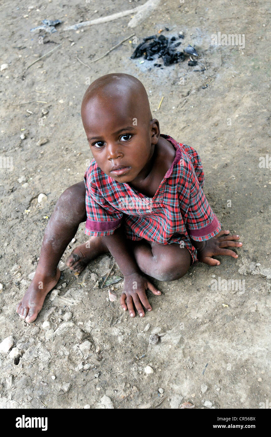 Poor boy sitting on ground hi-res stock photography and images - Alamy