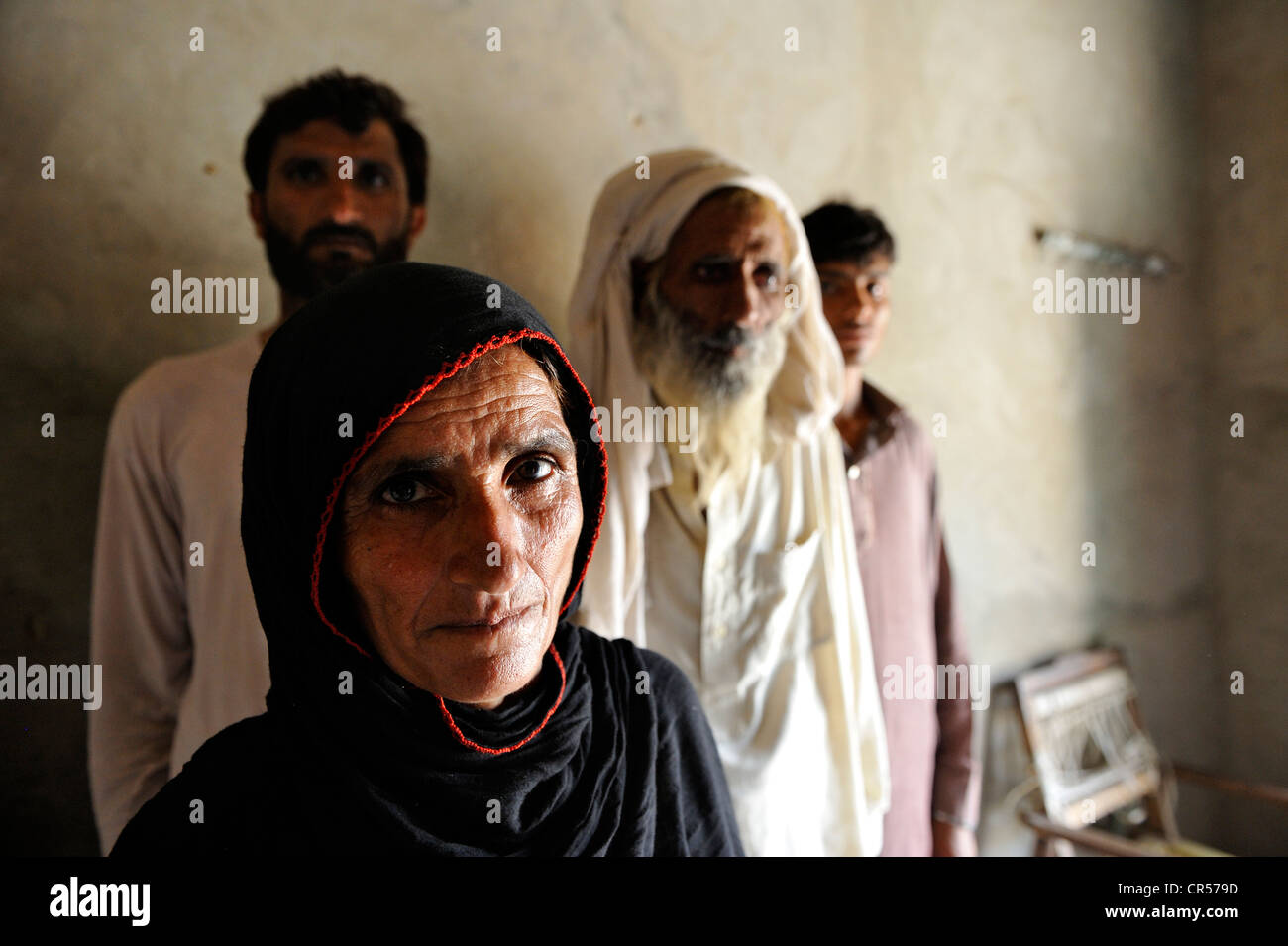 Woman is the head of the household as her much older husband is senile, Moza Sabgogat, Punjab, Pakistan, Asia Stock Photo