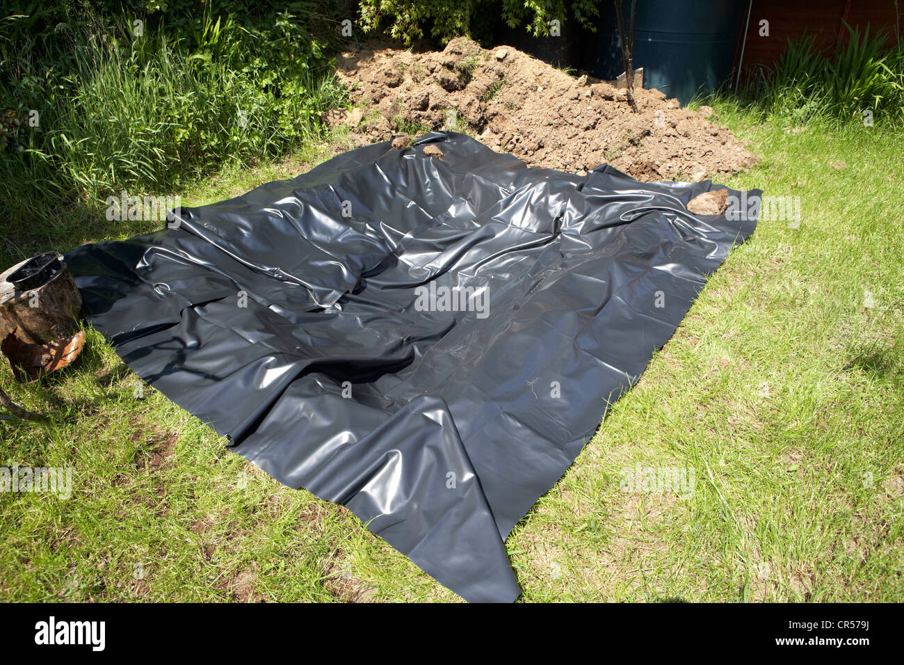 lining a hole dug to create a pond in a garden in the uk Stock Photo