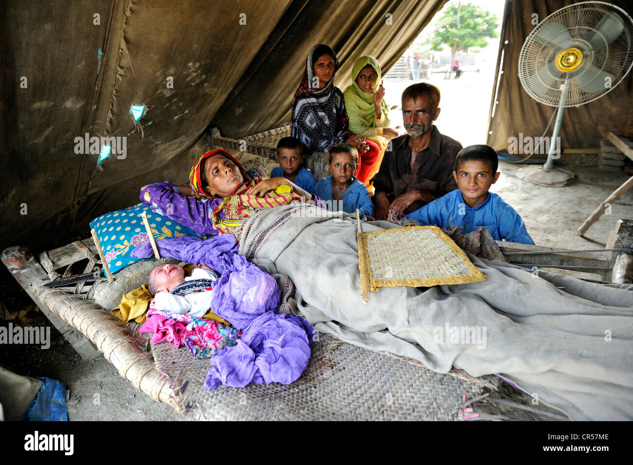 Family with newborn baby, they have been living in a tent since the flood disaster of 2010, Lashari Wala village, Punjab Stock Photo