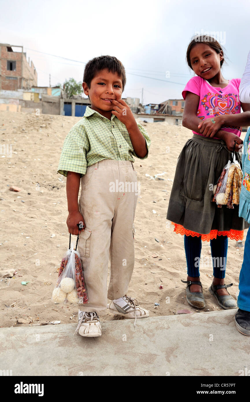 Child labour, a boy and a girl, siblings, selling nuts and candy on the streets, poor district of Villa El Salvador, Lima, Peru Stock Photo
