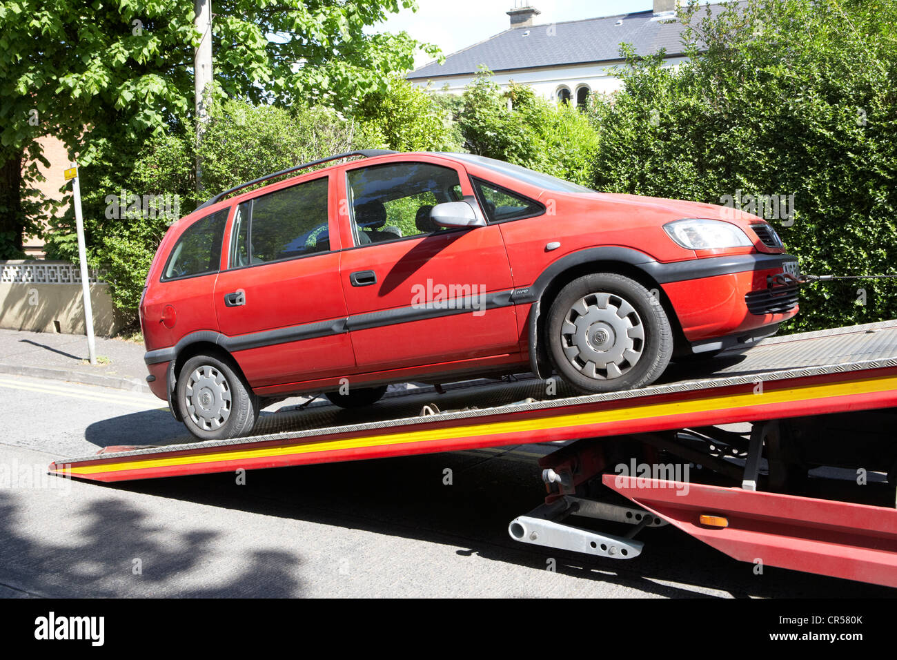 loading a broken down family car mpv onto a car transporter in the uk Stock Photo