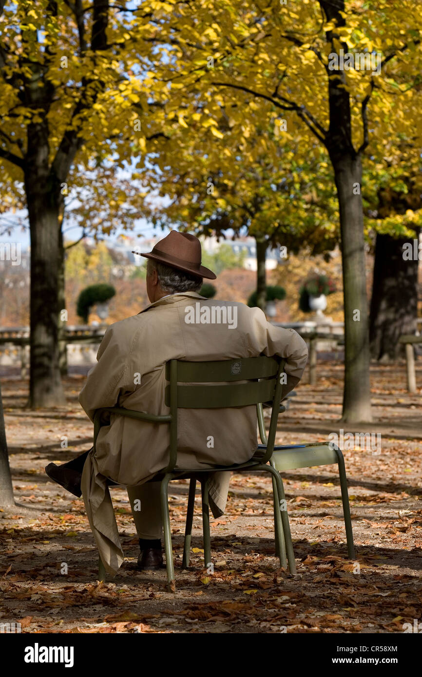 France, Paris, the Luxembourg Garden, man from the back sitting under trees Stock Photo