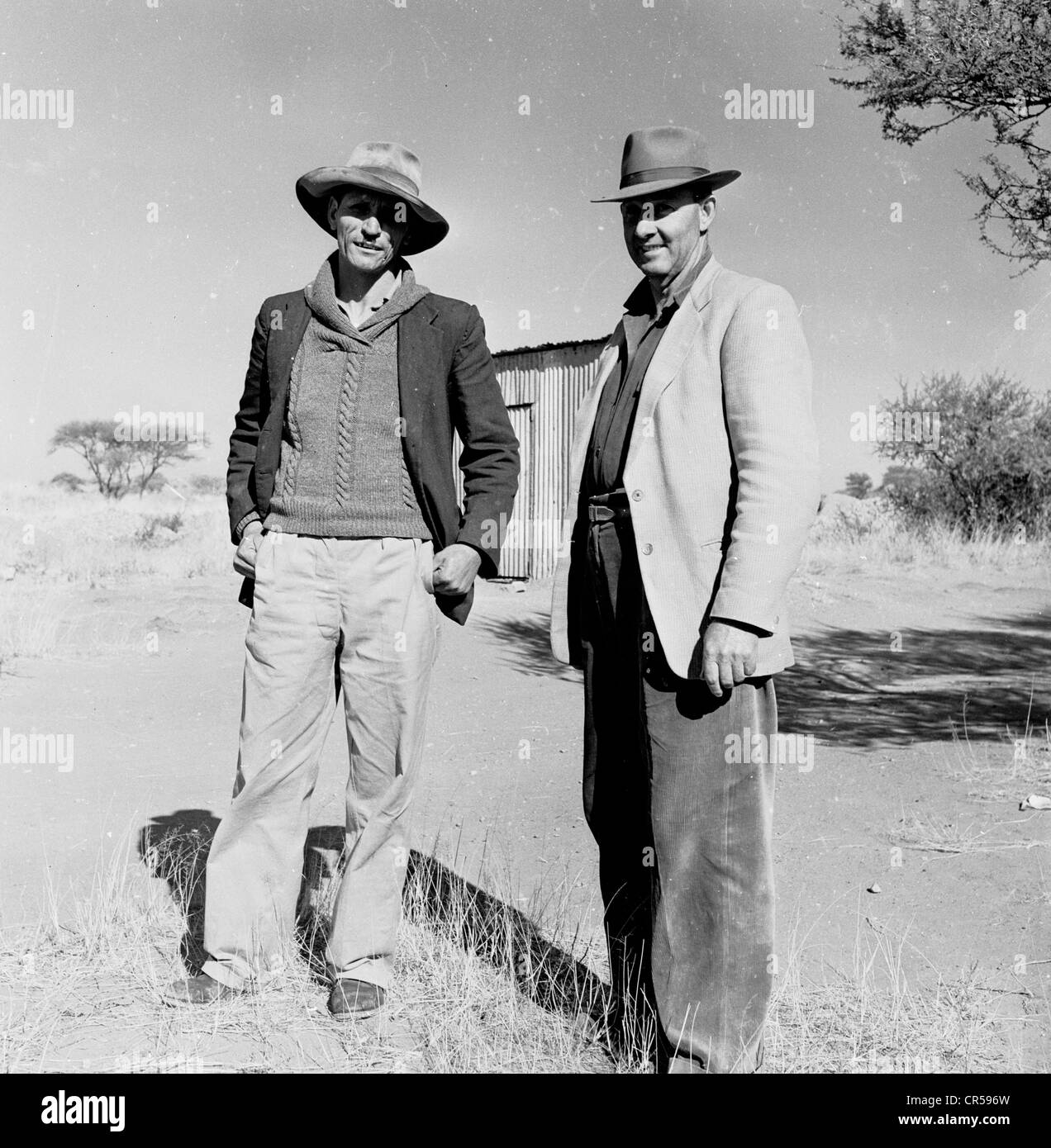 South Africa,1950s. Two local Afrikaan's stand in outback. Stock Photo