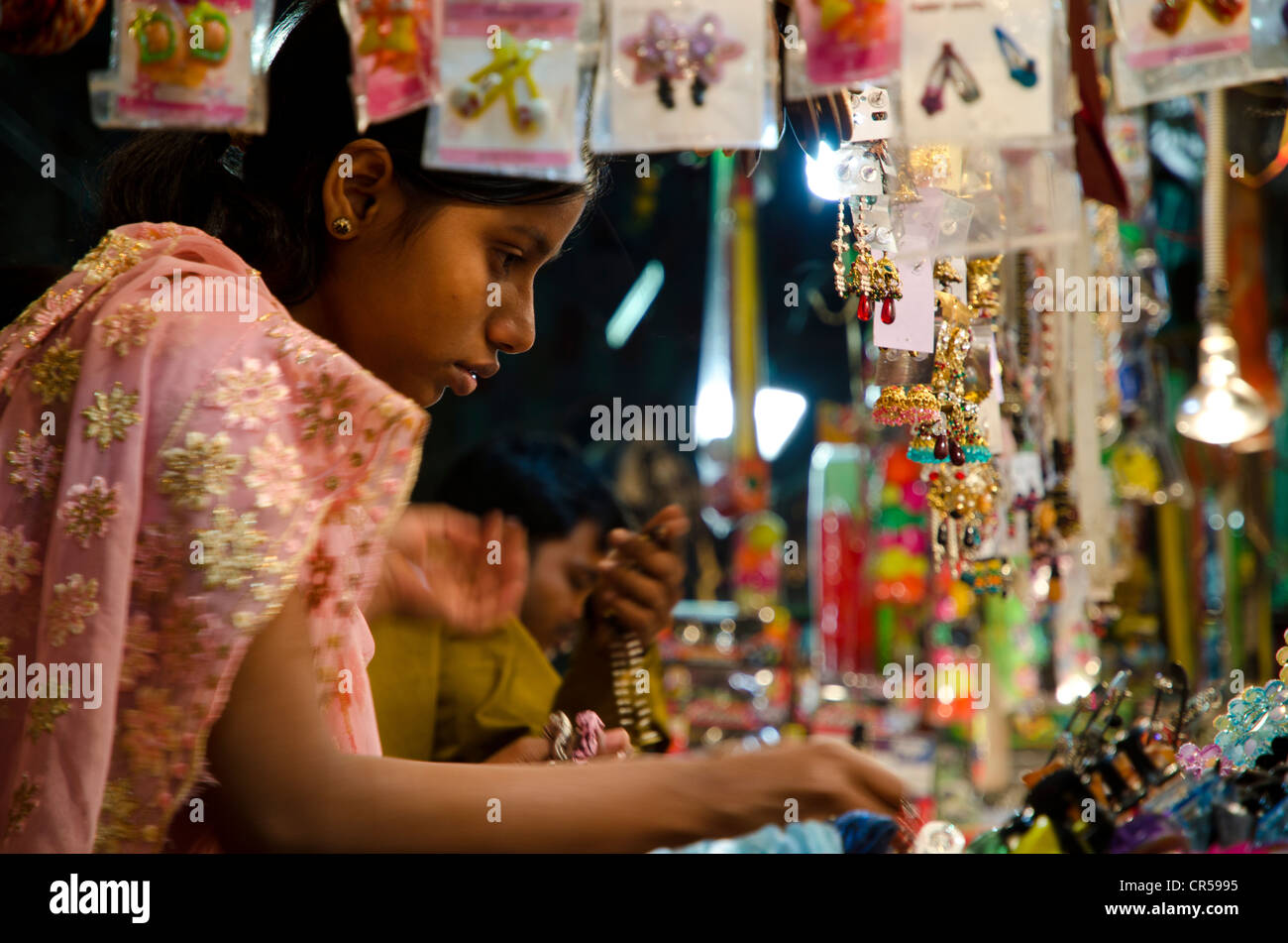 Young woman looking at bangles at street market, Kolkata, West Bengal, India, Asia Stock Photo
