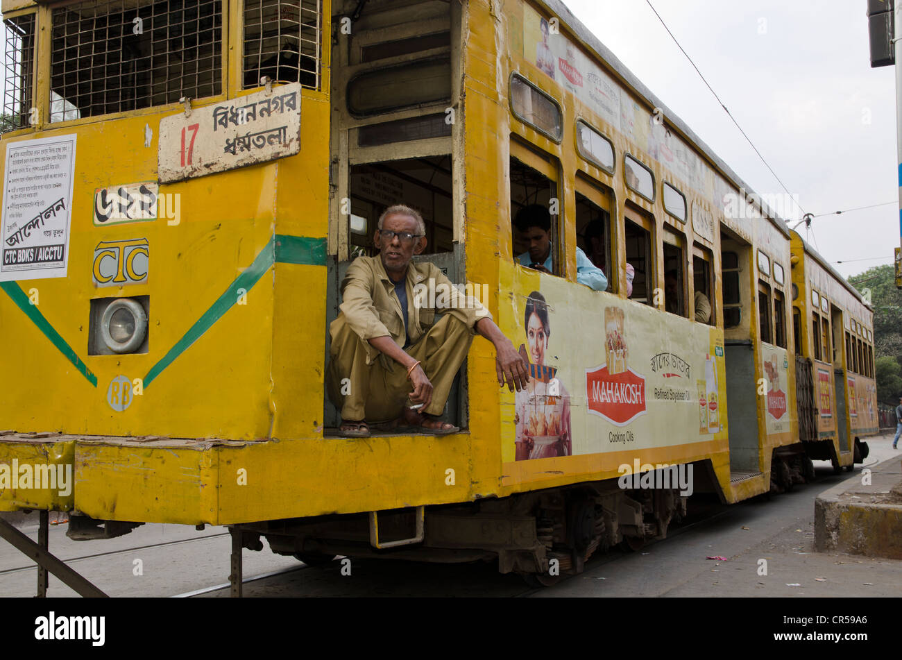 Driver of an old Kolkata tram resting at a red traffic-light, Kolkata, West Bengal, India, Asia Stock Photo