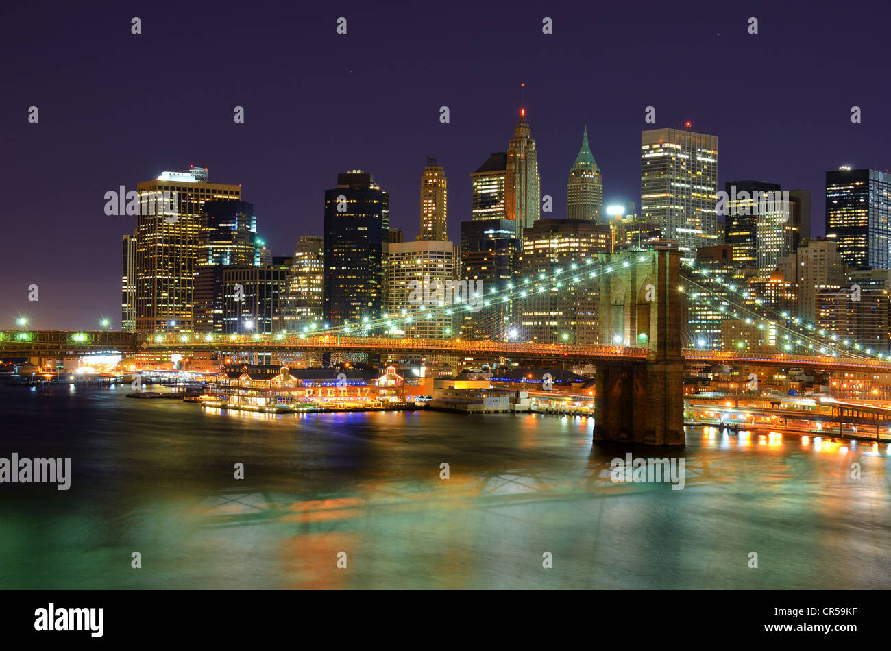 Brooklyn Bridge spans the East River towards Manhattan in New York, New York, USA. Stock Photo