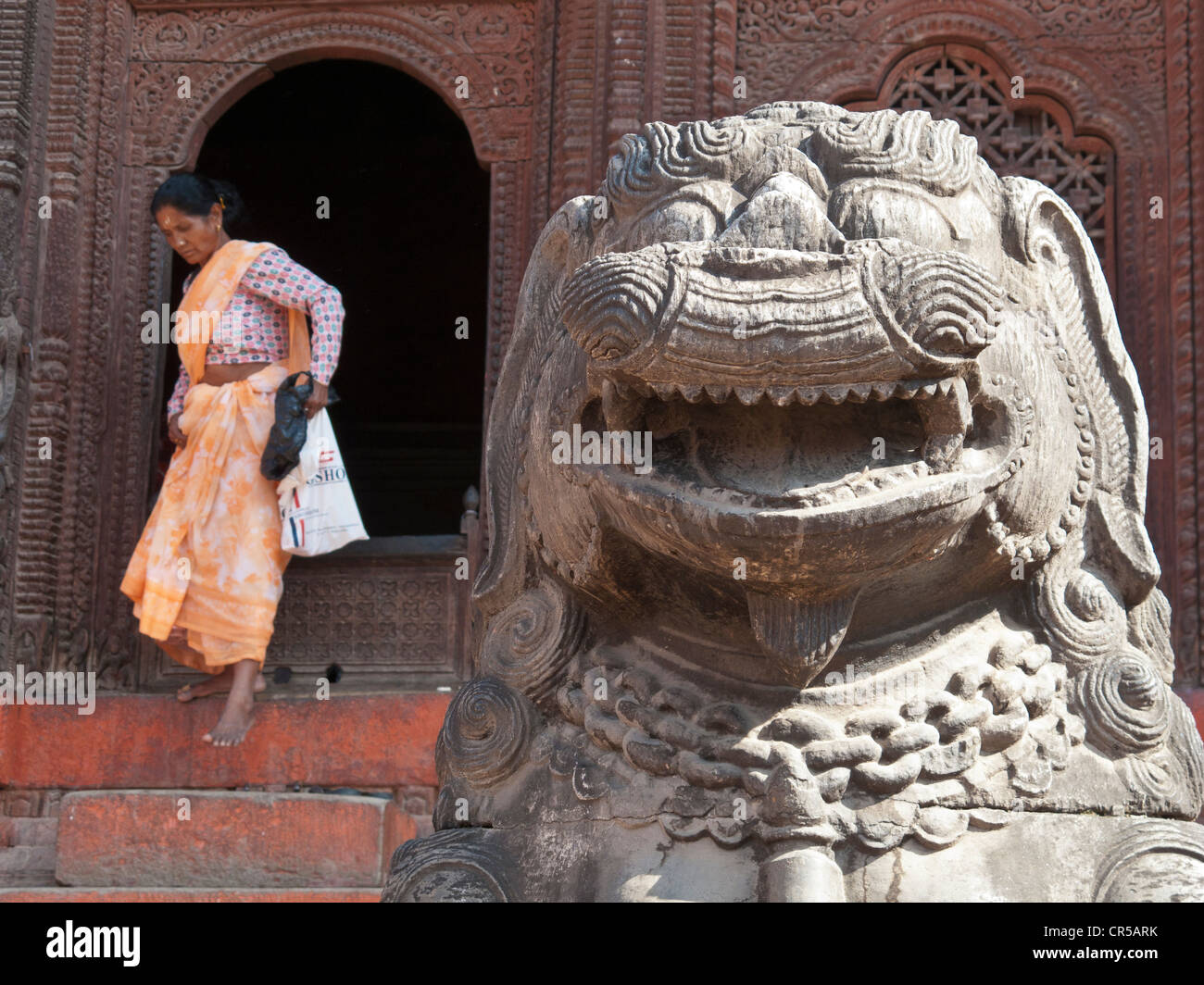 Devotee leaving a temple in Kathmandu, Nepal, South Asia Stock Photo