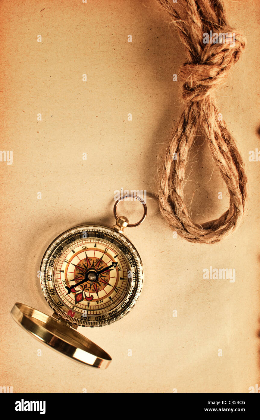 Vintage compass top shot over a grungy yellow paper Stock Photo - Alamy