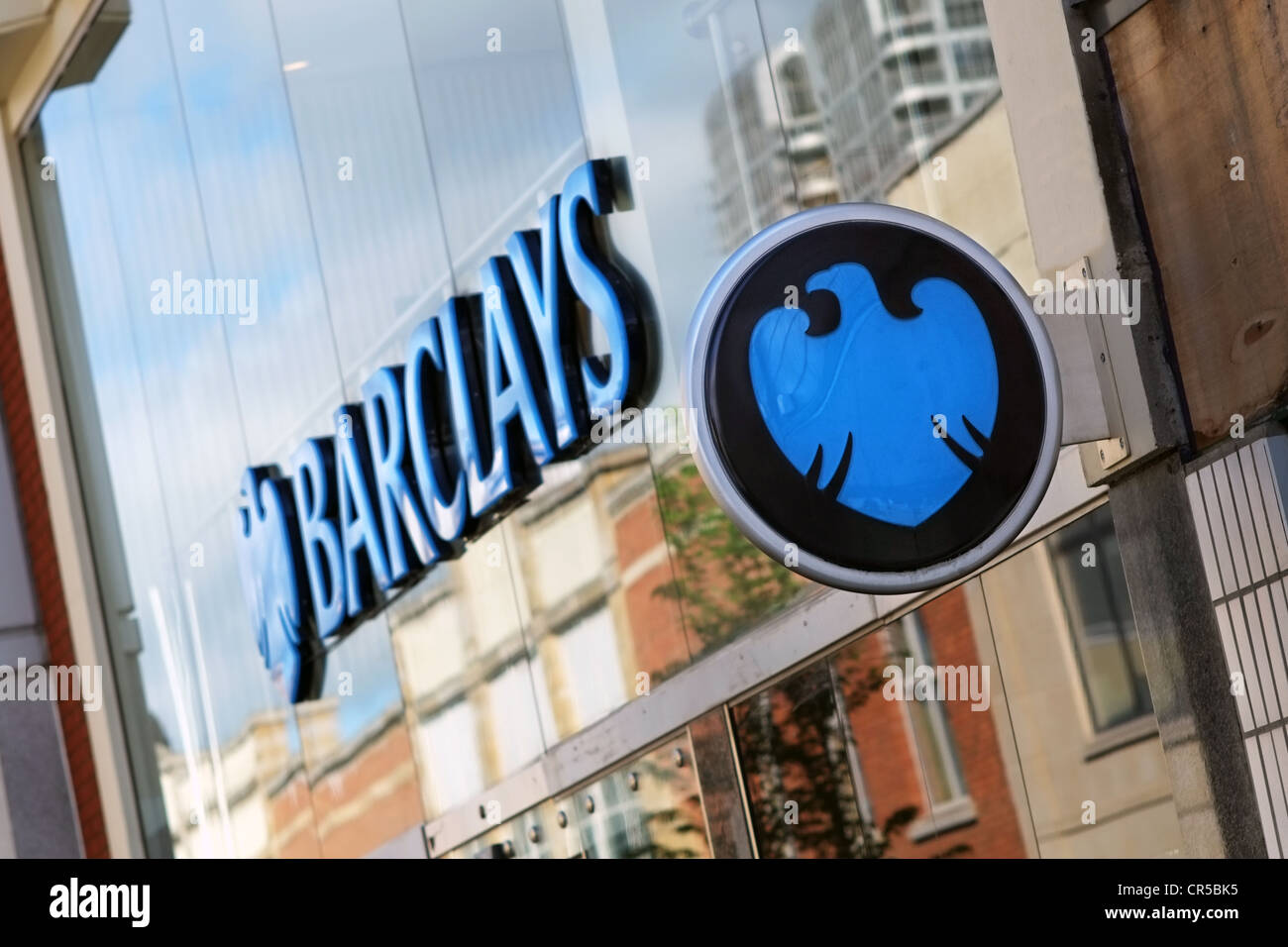 The front of a modern Barclays Bank showing a glass frontage & Sign ...