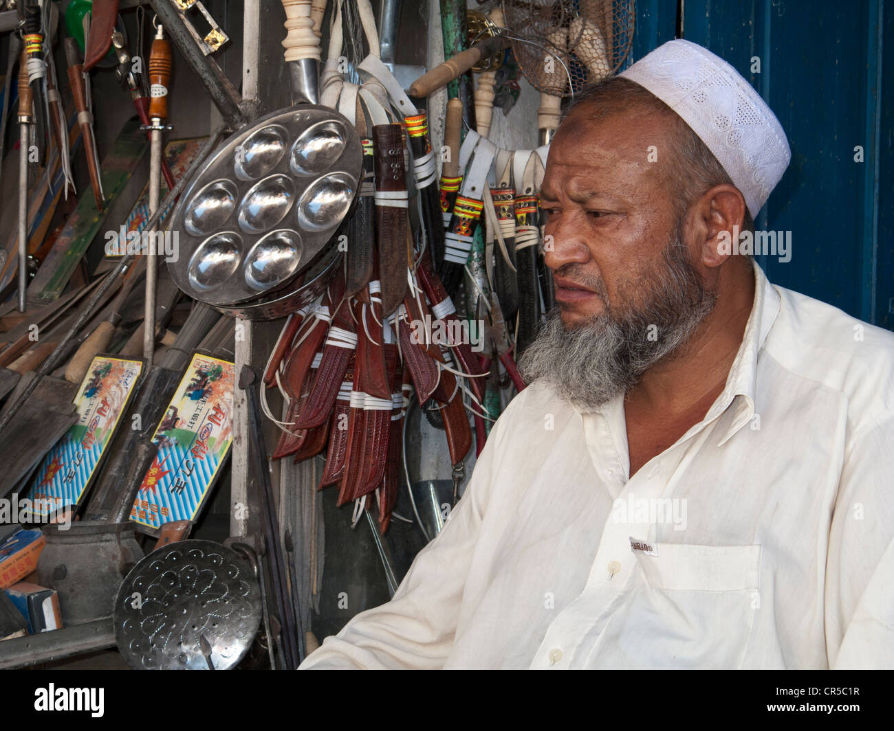Uigur merchant in the bazaar of Kashgar, Xinjiang, China, Asia Stock Photo