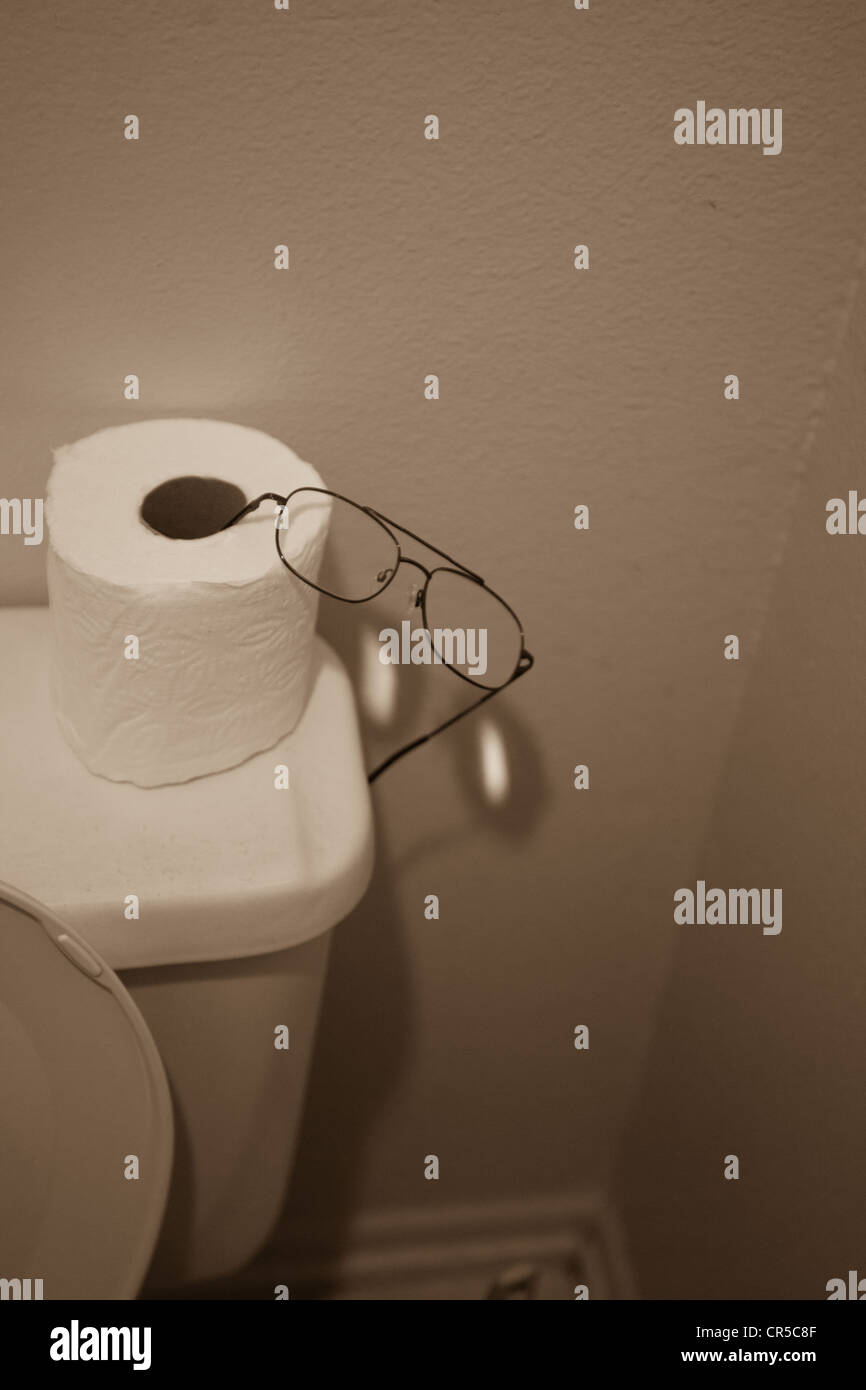 Someones reading glasses in the bathroom Stock Photo Alamy