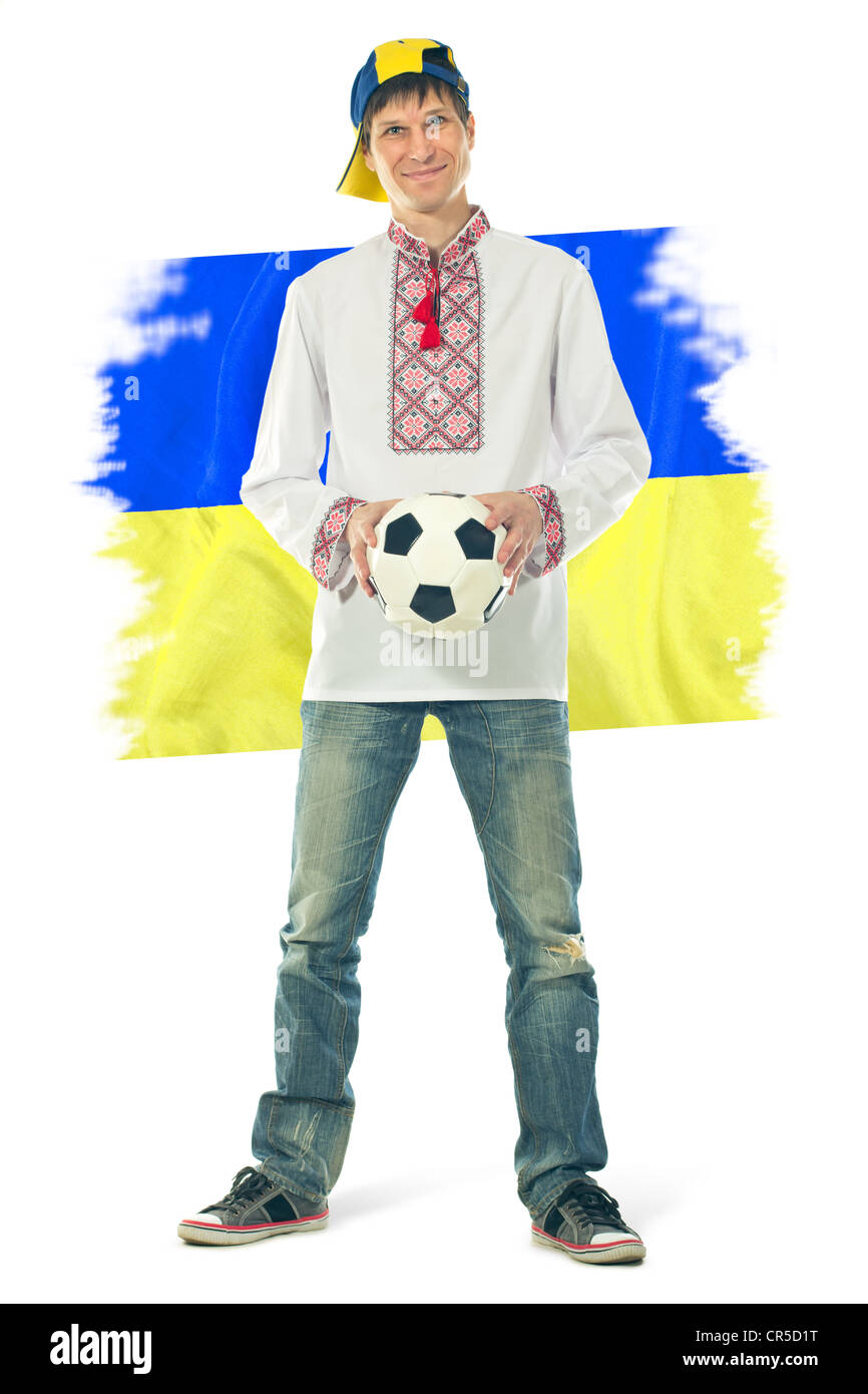 Ukrainian man in the national shirt with a ball and flag on a white background Stock Photo
