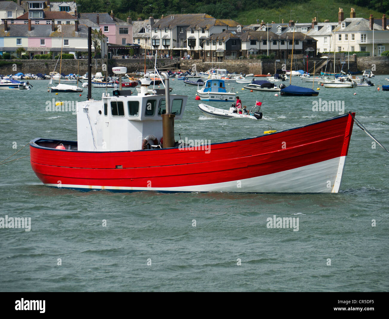 Small red and white fishing vessel in the Kingsbridge Estuary at Salcombe in Devon England Stock Photo