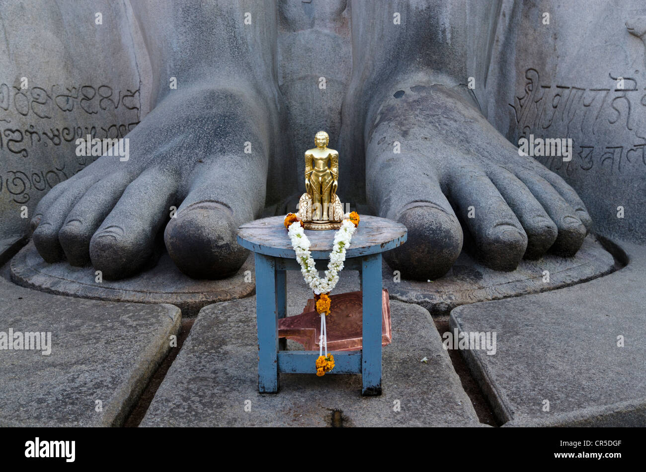 The small statue of Bahubali at the feet of the gigantic statue of Gomateshwara in Sravanabelagola, used for special rituals Stock Photo