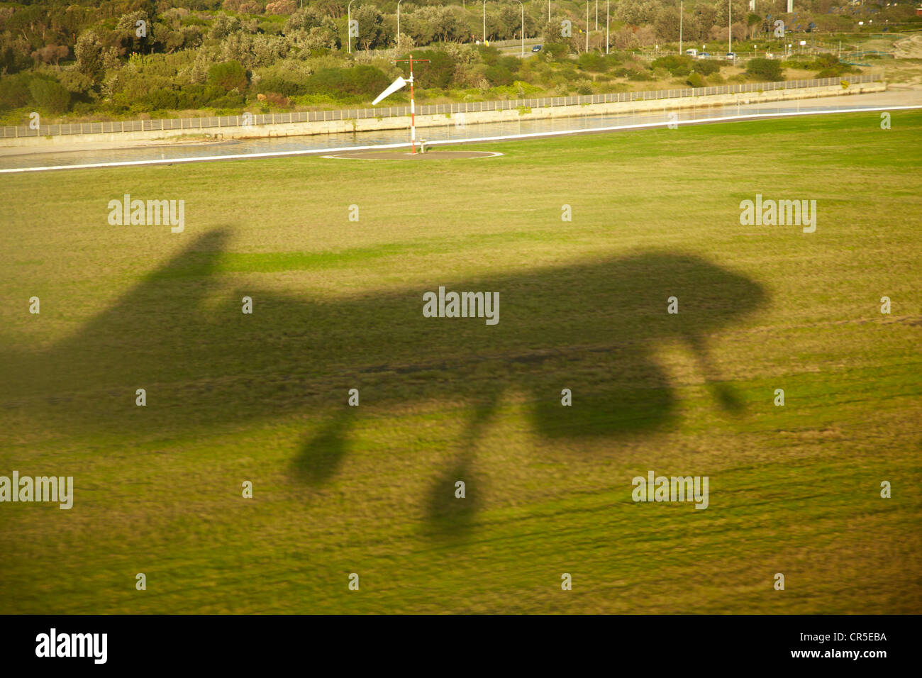 Shadow of plane landing at Sydney Airport, Sydney, New South Wales, Australia - aerial Stock Photo