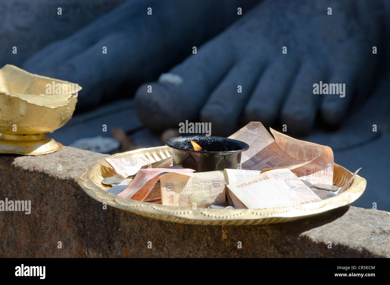 Offerings from pilgrims who receive the blessings of Bahubali by local priests on Indragiri hill in , India, Asia Stock Photo