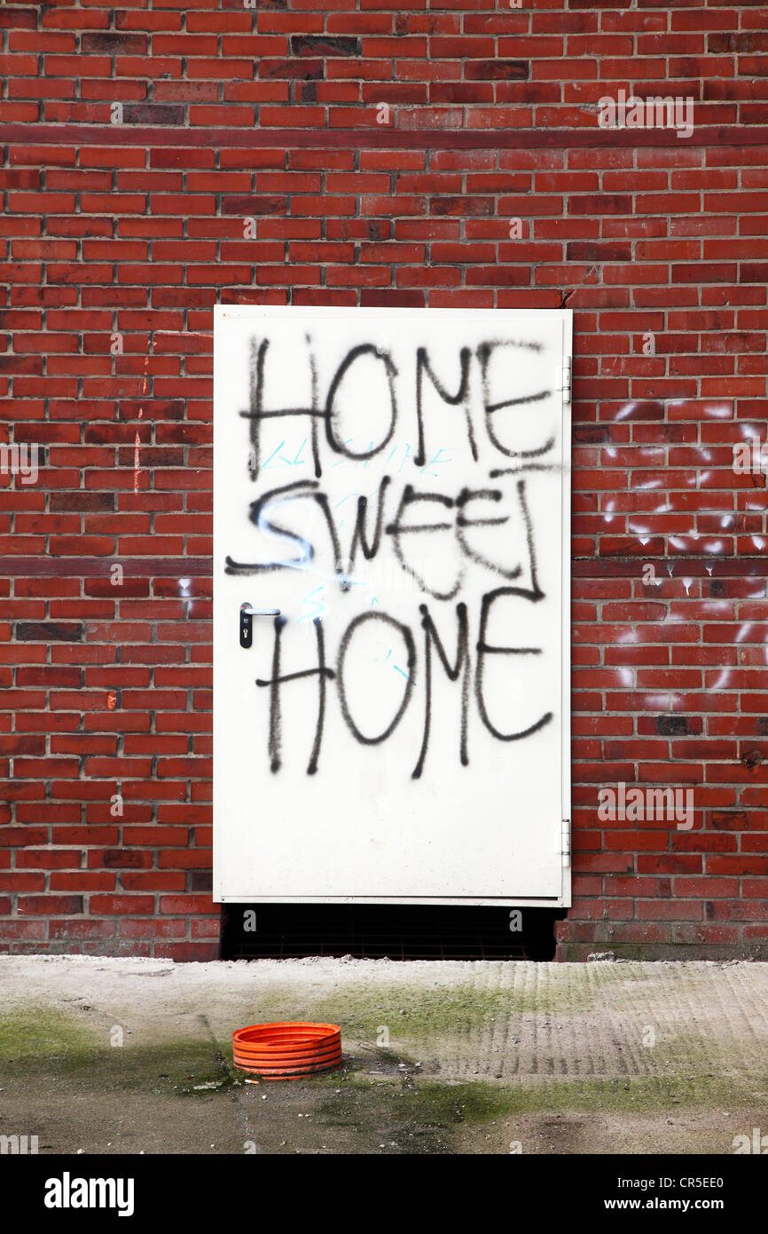 Graffiti "Home Sweet Home" on a condemned building door of an old industrial building. Herten, North Rhine-Westphalia, Germany, Stock Photo