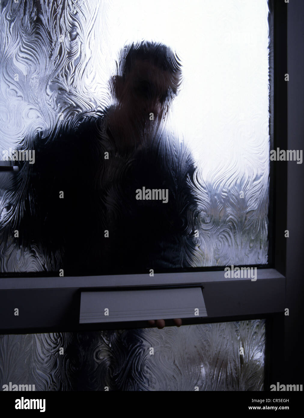 Silhouette Of A Man Behind Frosted Glass Door Outside Looking In Silhouette Of A Man Behind Frosted Glass Door Outside Looking In Posed By Models