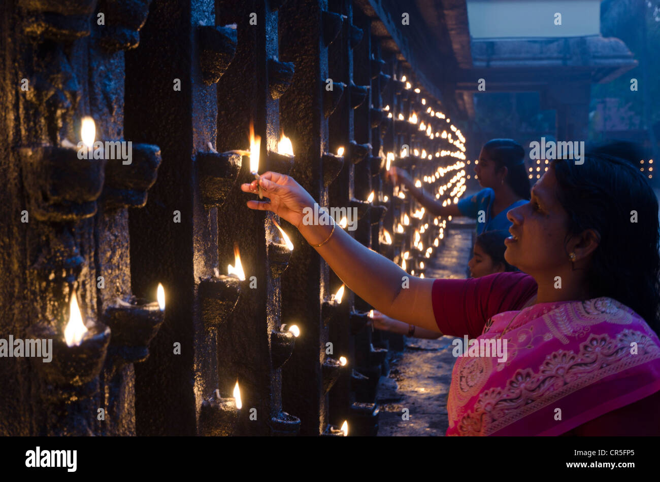Woman offering candles as part of the evening prayer in the Janardana-Swami-Temple of Varkala, Kerala, India, Asia Stock Photo