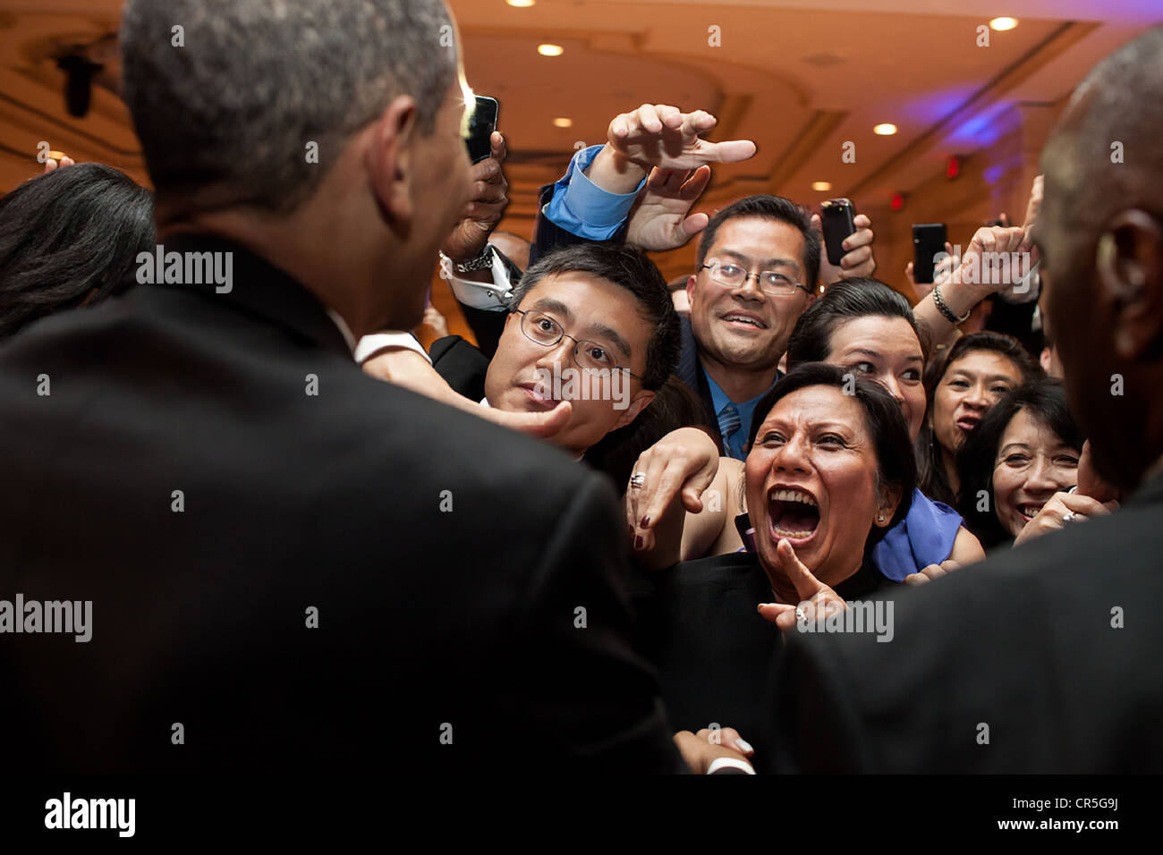 US President Barack Obama greets people in the audience after delivering the keynote address at the Asian Pacific American Institute for Congressional Studies 18th Annual Gala Dinner May 8, 2012. in Washington, DC Stock Photo