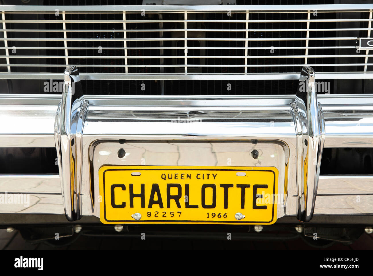 A 1966 Charlotte city tag on the front bumper of a vintage car in uptown Charlotte, North Carolina, USA Stock Photo