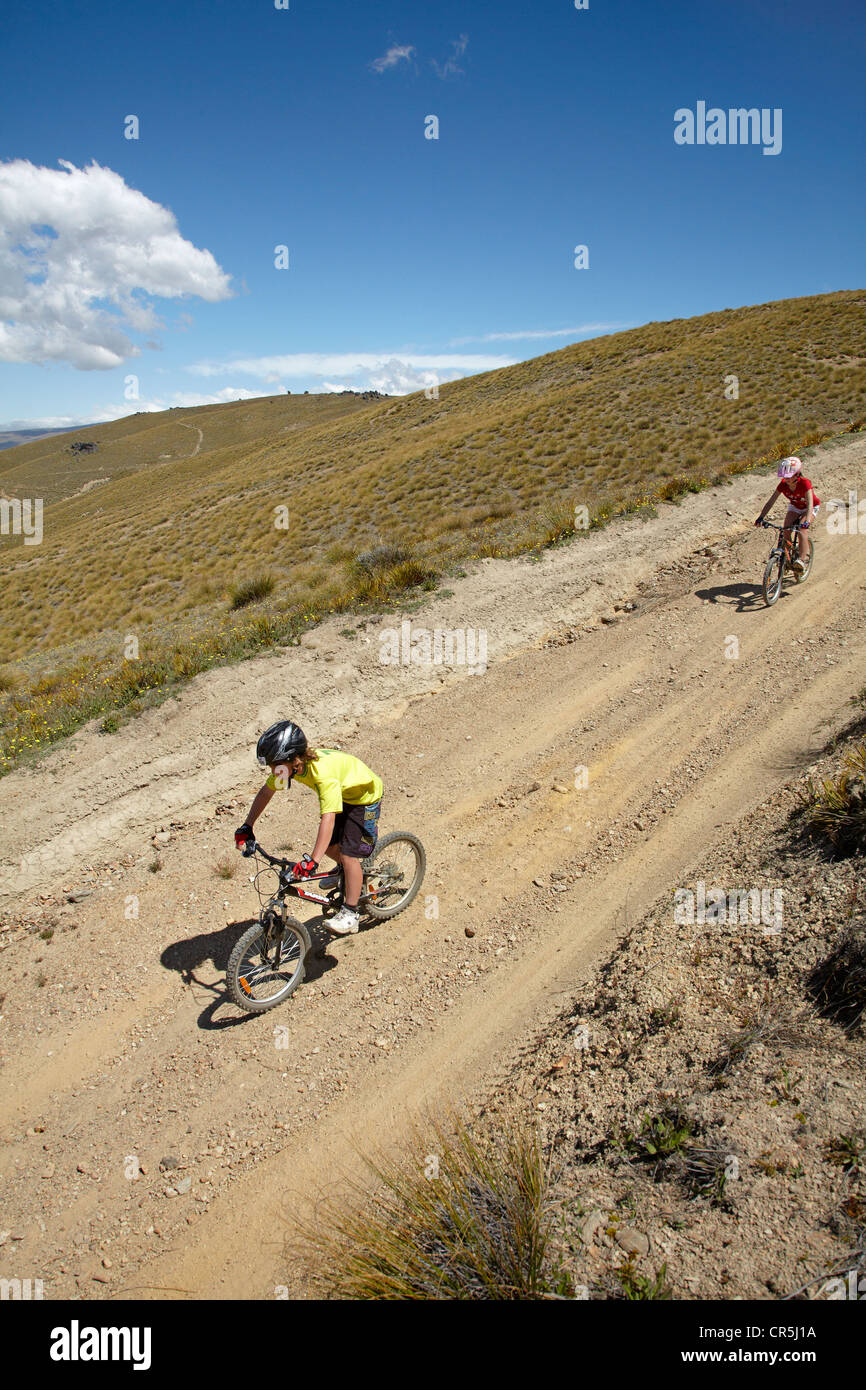 Young mountain bikers, Carrick Track, Carrick Range, Central Otago, South Island, New Zealand Stock Photo